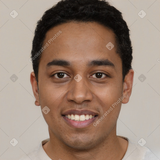 Joyful black young-adult male with short  black hair and brown eyes