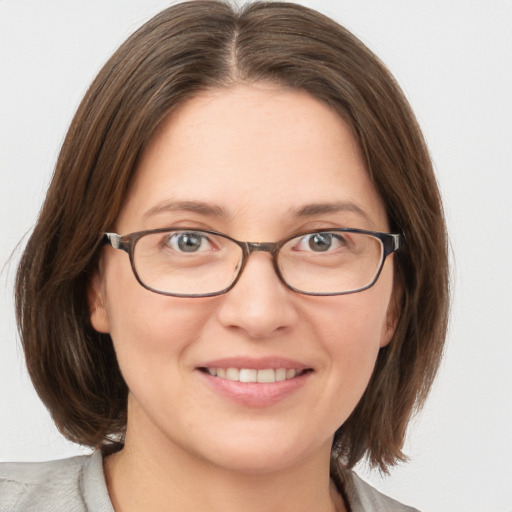 Joyful white young-adult female with medium  brown hair and blue eyes