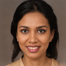 Joyful black young-adult female with medium  brown hair and brown eyes