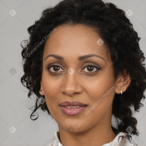 Joyful black adult female with medium  brown hair and brown eyes