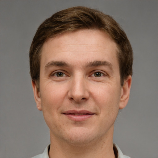 Joyful white adult male with short  brown hair and grey eyes