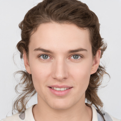 Joyful white young-adult female with medium  brown hair and grey eyes