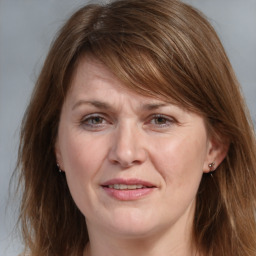 Joyful white adult female with medium  brown hair and grey eyes