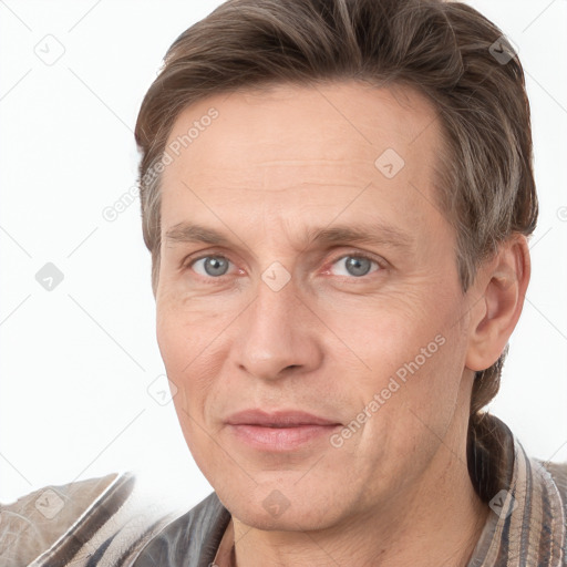 Joyful white adult male with short  brown hair and grey eyes