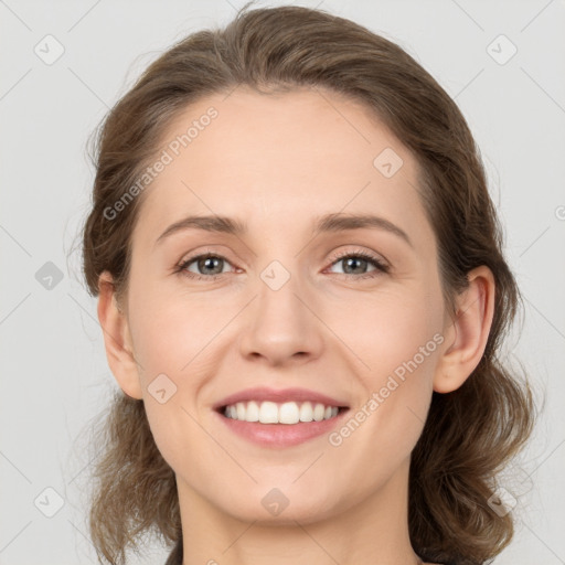 Joyful white young-adult female with medium  brown hair and green eyes