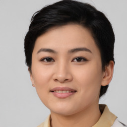 Joyful asian young-adult female with short  brown hair and brown eyes