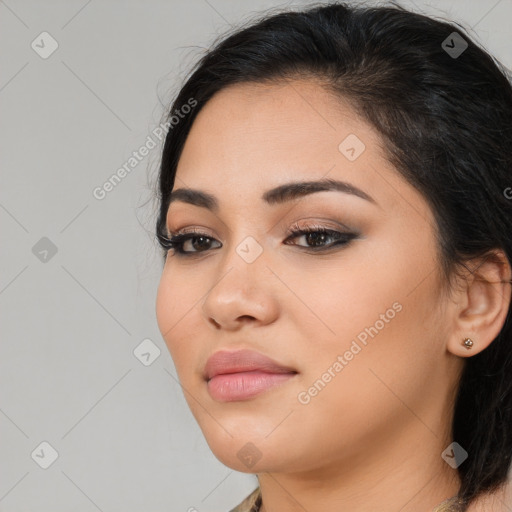 Joyful latino young-adult female with long  brown hair and brown eyes