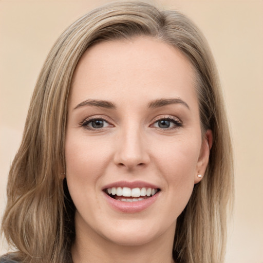 Joyful white young-adult female with long  brown hair and green eyes