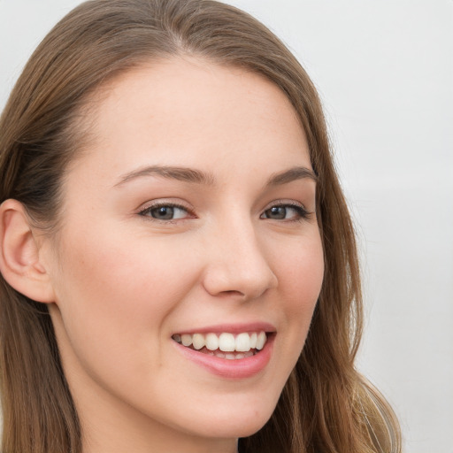 Joyful white young-adult female with long  brown hair and grey eyes