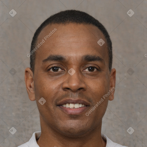 Joyful black young-adult male with short  black hair and brown eyes