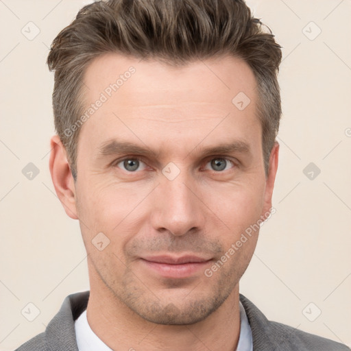 Joyful white adult male with short  brown hair and grey eyes