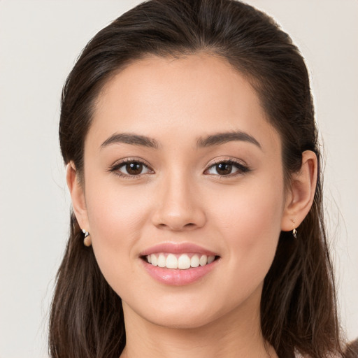 Joyful white young-adult female with long  brown hair and brown eyes