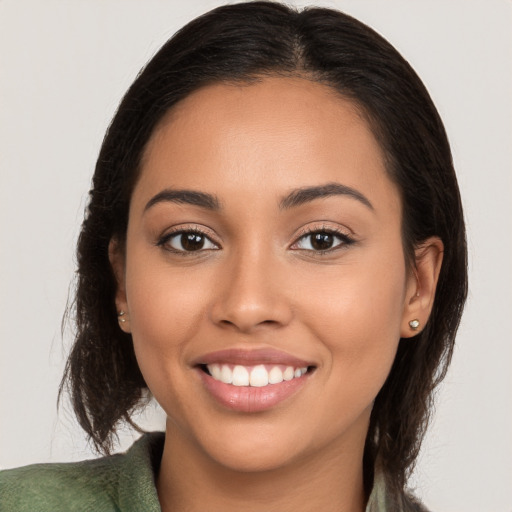 Joyful latino young-adult female with long  brown hair and brown eyes