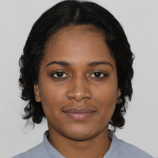 Joyful black young-adult female with medium  black hair and brown eyes
