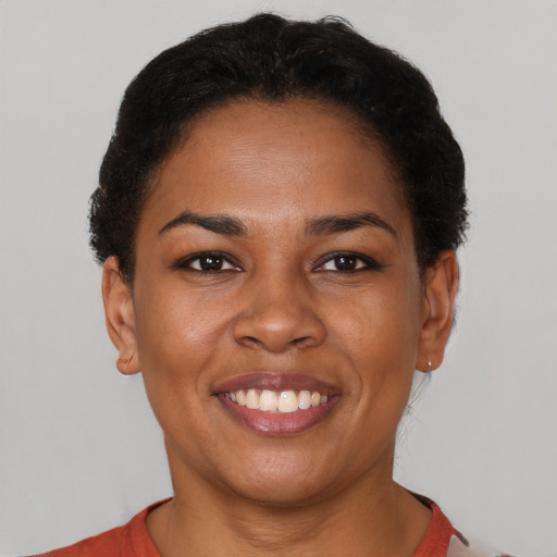 Joyful latino young-adult female with short  brown hair and brown eyes