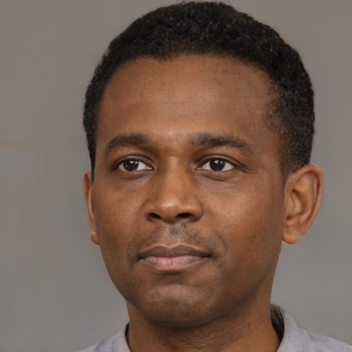 Neutral black young-adult male with short  black hair and brown eyes
