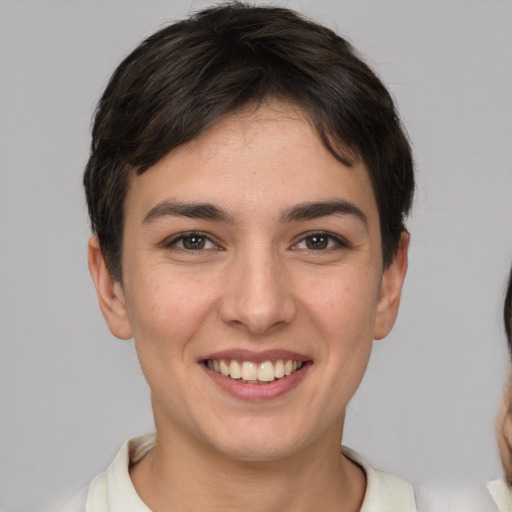 Joyful white young-adult female with short  brown hair and brown eyes