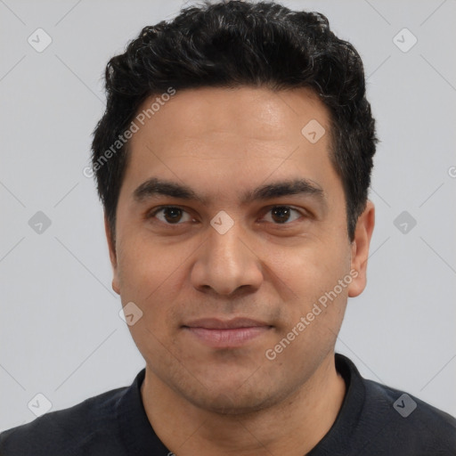 Joyful latino young-adult male with short  black hair and brown eyes