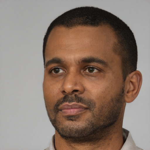 Neutral black young-adult male with short  black hair and brown eyes