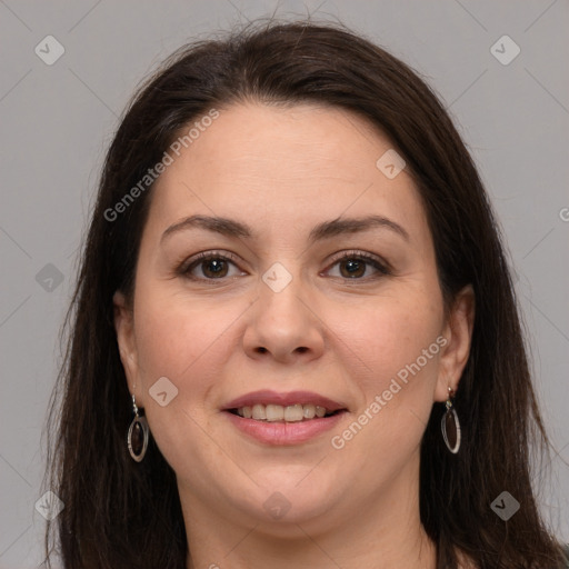 Joyful white adult female with long  brown hair and brown eyes