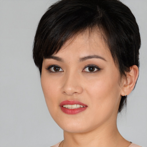 Joyful white young-adult female with short  black hair and brown eyes
