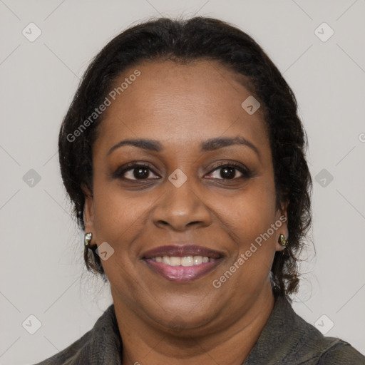 Joyful black adult female with long  brown hair and brown eyes