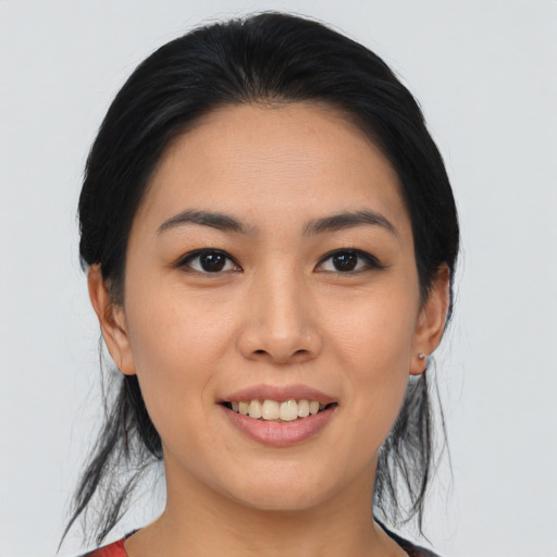 Joyful asian young-adult female with medium  black hair and brown eyes