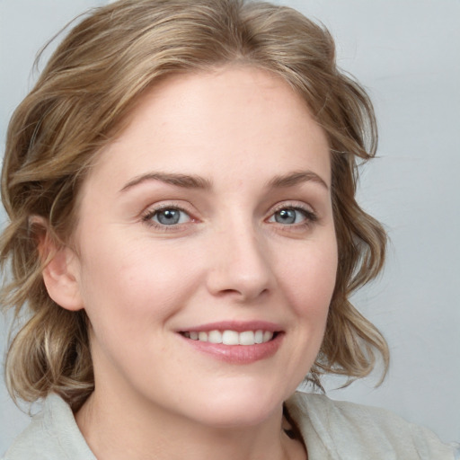 Joyful white young-adult female with medium  brown hair and blue eyes