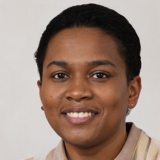 Joyful black young-adult female with short  black hair and brown eyes