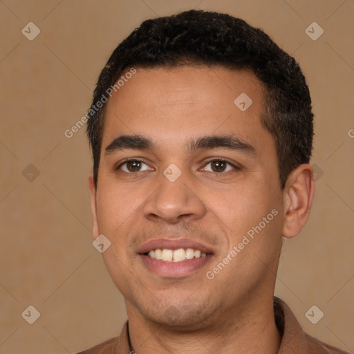 Joyful latino young-adult male with short  brown hair and brown eyes