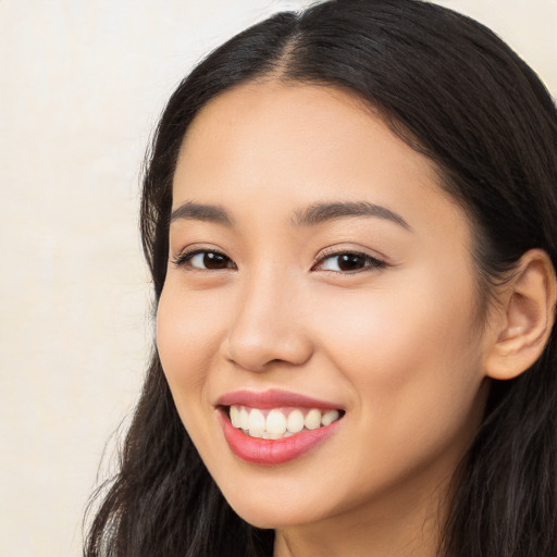 Joyful latino young-adult female with long  black hair and brown eyes