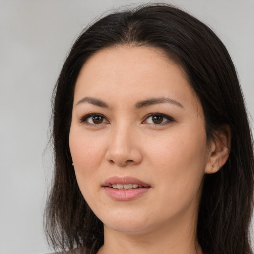 Joyful asian young-adult female with long  brown hair and brown eyes