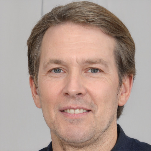 Joyful white adult male with short  brown hair and grey eyes