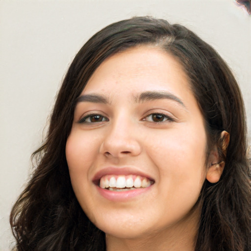 Joyful white young-adult female with long  black hair and brown eyes