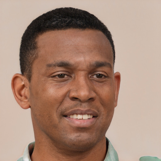Joyful latino young-adult male with short  brown hair and brown eyes