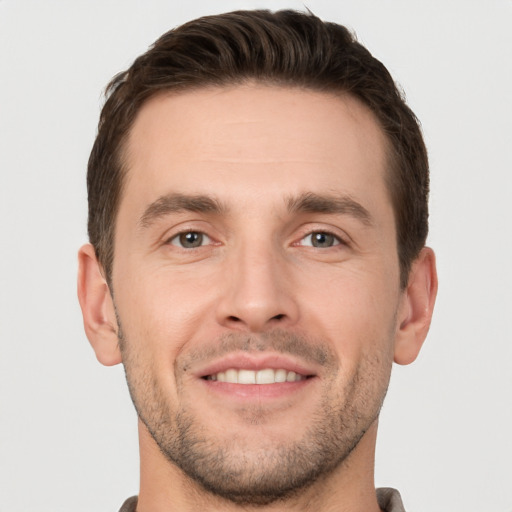 Joyful white young-adult male with short  brown hair and brown eyes