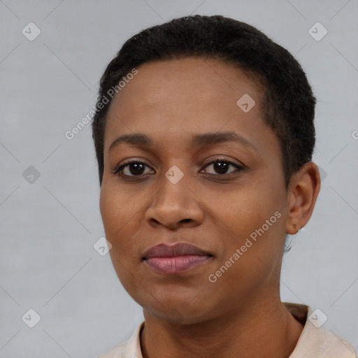 Joyful black young-adult female with short  black hair and brown eyes