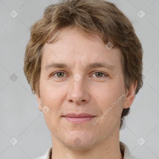 Joyful white adult male with short  brown hair and grey eyes