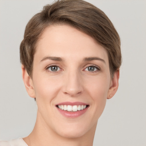 Joyful white young-adult female with short  brown hair and grey eyes