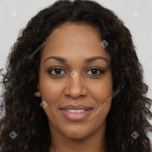 Joyful black young-adult female with long  brown hair and brown eyes