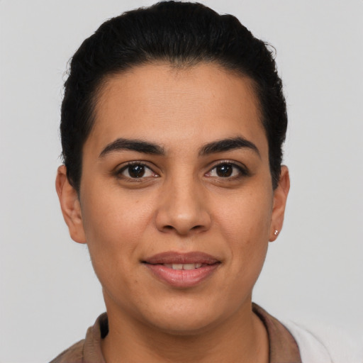 Joyful latino young-adult female with short  brown hair and brown eyes