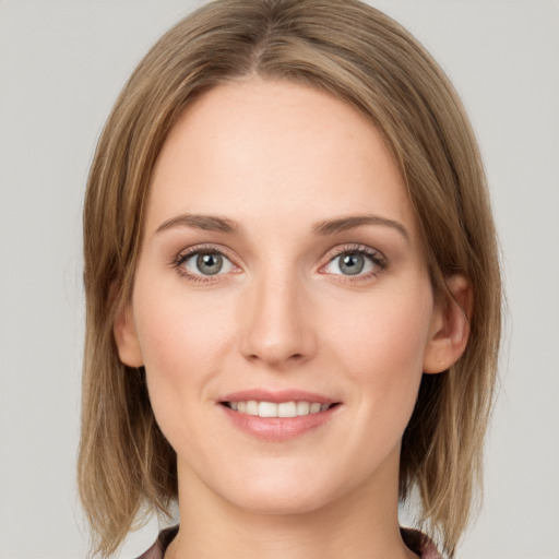 Joyful white young-adult female with medium  brown hair and green eyes