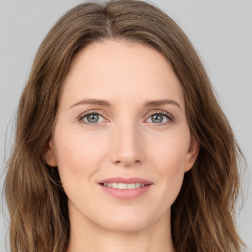 Joyful white young-adult female with long  brown hair and grey eyes