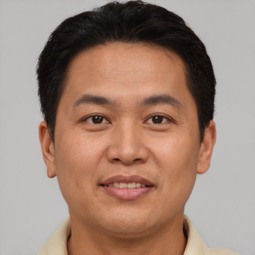 Joyful asian young-adult male with short  brown hair and brown eyes