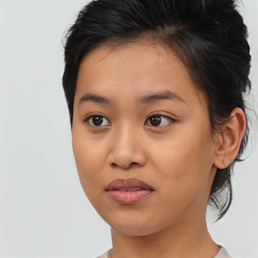 Joyful asian young-adult female with medium  brown hair and brown eyes
