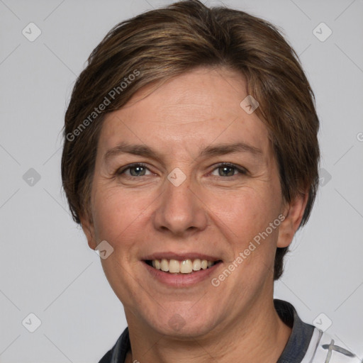 Joyful white adult female with short  brown hair and grey eyes