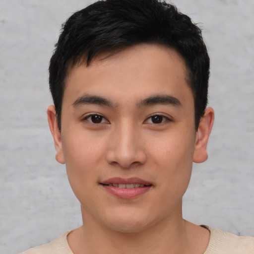 Joyful asian young-adult male with short  brown hair and brown eyes
