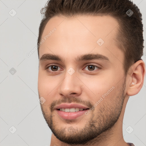 Joyful white young-adult male with short  brown hair and brown eyes