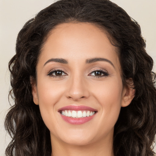 Joyful white young-adult female with long  brown hair and brown eyes