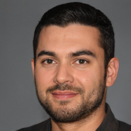 Joyful white young-adult male with short  black hair and brown eyes